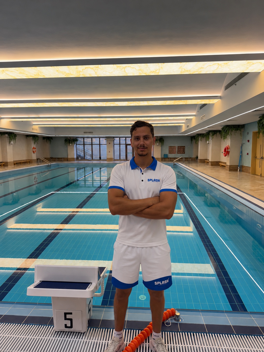 Coach Chams of Splash Swimming Club by the pool at Newton School
